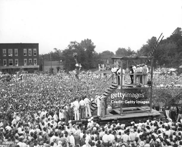 Huge crowd of over 15, 000 people gathers around a scaffold to witness the public hanging of 26-year old Rainey Bethea August 14, 1936 in Owensboro,...