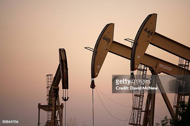 Oil rigs extract petroleum as the price of crude oil rises to nearly $120 per barrel, prompting oil companies to reopen numerous wells across the...