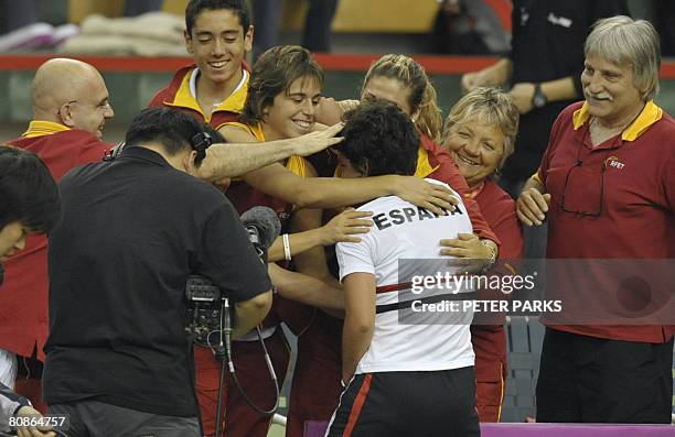 The Spanish team celebrate after the five-times champions took first blood in their Fed Cup semi-final against China with Carla Suarez Navarro...