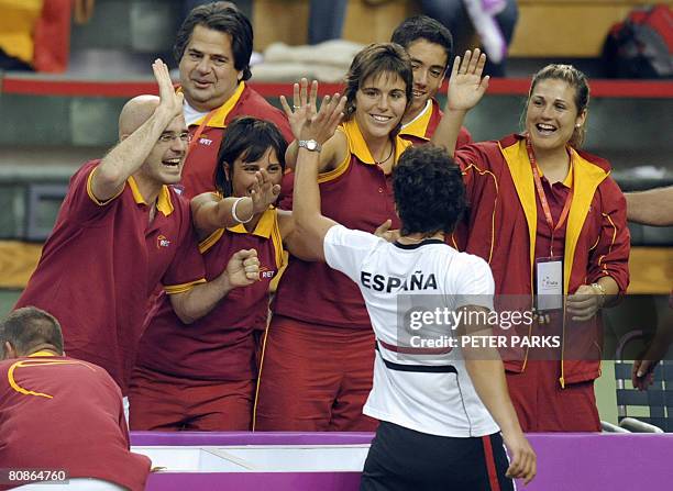 The Spanish team celebrate after the five-times champions took first blood in their Fed Cup semi-final against China with Carla Suarez Navarro...