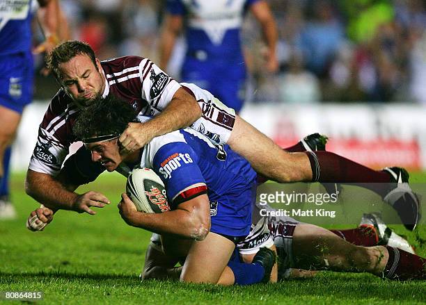 Glenn Stewart of the Sea Eagles tackles Danny Williams of the Bulldogs during the round seven NRL match between the Manly Warringah Sea Eagles and...