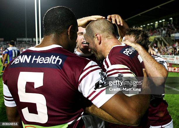 Steve Bell of the Sea Eagles celebrates with team mates after scoring a try in the corner during the round seven NRL match between the Manly...