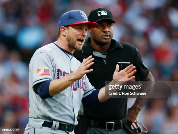 Manager Andy Green of the San Diego Padres argues with home plate umpire Alan Porter after an infield single by Bradley Zimmer of the Cleveland...