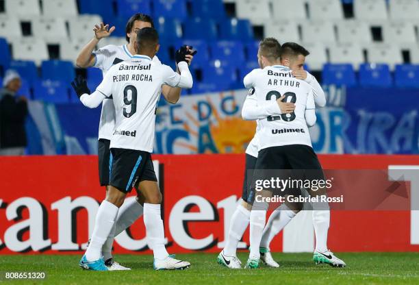 Ramiro of Gremio celebrates with teammates Pedro Rocha and Arthur after scoring the opening goal of his team during a first leg match between Godoy...