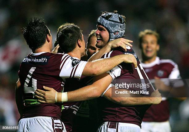 Adam Cuthbertson of the Sea Eagles celebrates with team mates after scoring a try during the round seven NRL match between the Manly Warringah Sea...