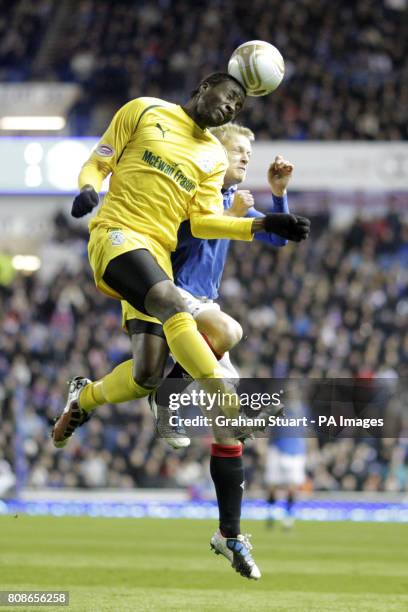 Rangers' Steven Naismith and Hibernian's Souleymane Bamba battle for the ball in the air