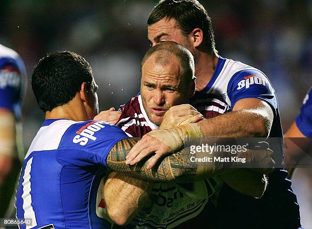 Steve Bell of the Sea Eagles is tackled during the round seven NRL match between the Manly Warringah Sea Eagles and the Bulldogs at Brookvale Oval on...