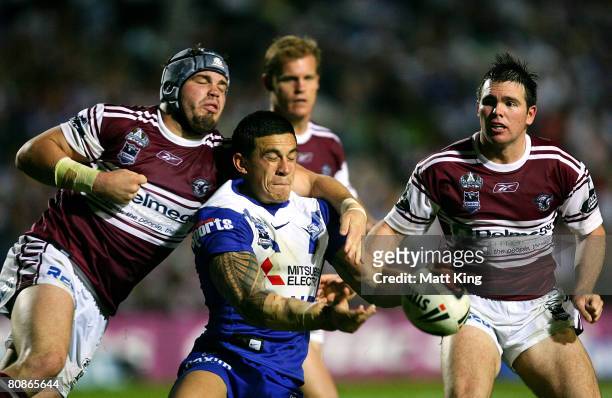 Sonny Bill Williams of the Bulldogs gets a pass away in front of Adam Cuthbertson of the Sea Eagles during the round seven NRL match between the...
