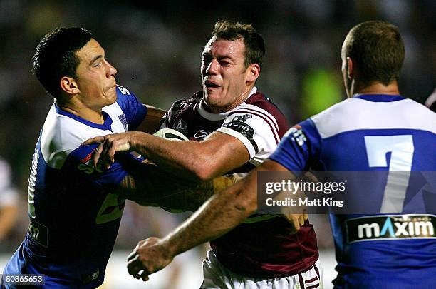 Heath L'Estrange of the Sea Eagles is tackled by Sonny Bill Williams of the Bulldogs during the round seven NRL match between the Manly Warringah Sea...