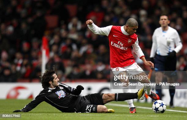 Partizan Belgrade's Stefan Babovic slides in to challenge Arsenal's Neves Denilson