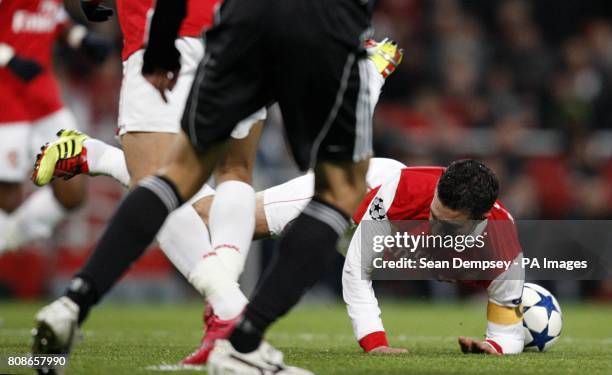 Arsenal's Robin van Persie goes to ground after a challenge by Partizan Belgrade's Marko Jovanovic resulting in a penalty