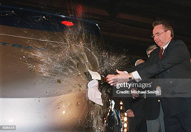 Wisconsin Governor Tommy Thompson christens the nation's first high-speed train, Amtrak's Acela Express, prior to its departure from Union Station...