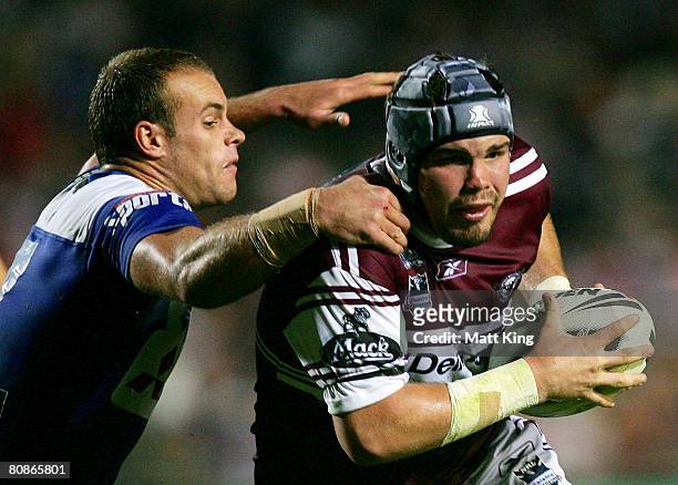 Adam Cuthbertson of the Sea Eagles tries to pass Daniel Holdsworth of the Bulldogs during the round seven NRL match between the Manly Warringah Sea...