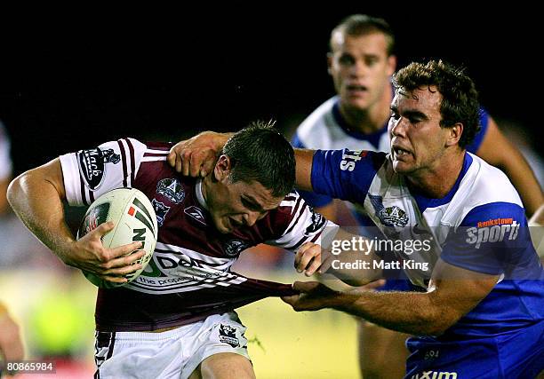 Matt Ballin of the Sea Eagles is tackled by Gary Warburton of the Bulldogs during the round seven NRL match between the Manly Warringah Sea Eagles...