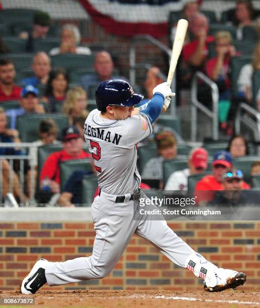 Alex Bregman of the Houston Astros hits a single in the fifth inning to knock in Yuli Gurriel against the Atlanta Braves at SunTrust Park on July 4,...