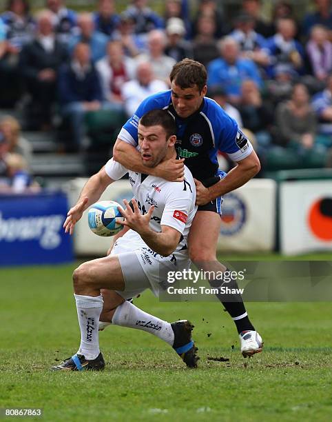 Chris Bell of Sale is tackled by Olly Barkley of Bath during the European Challenge Cup Semi Final match between Bath and Sale Sharks at the...