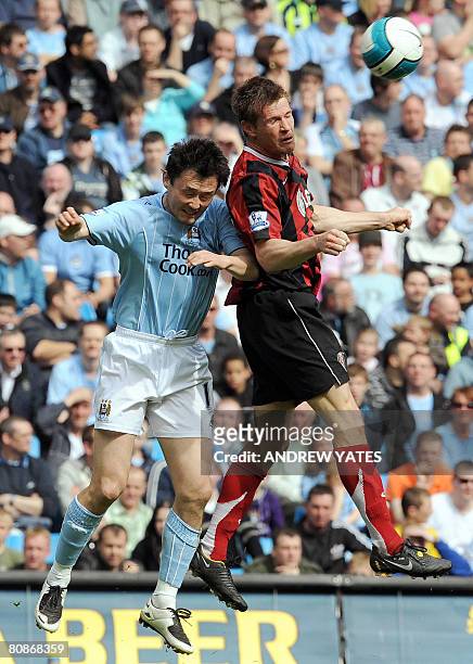 Manchester City's Chinese defender Sun Jihai vies with Fulham's Brian McBride during the English Premier league football match at The City of...