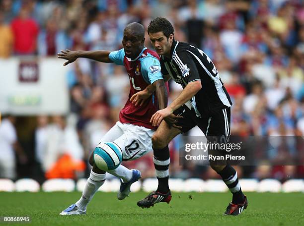 David Edgar of Newcastle United is challenged by Carlton Cole of West Ham United during the Barclays Premier League match between West Ham United and...