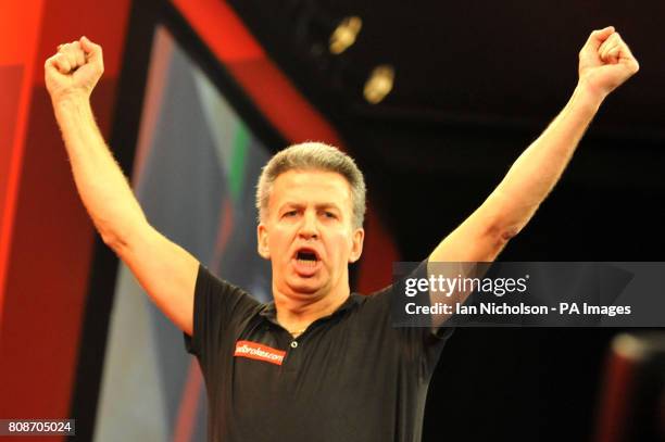 Magnus Caris celebrates in his First Round match with Dietmar Burger during the Ladbrokes.com World Darts Championship at Alexandra Palace, London.