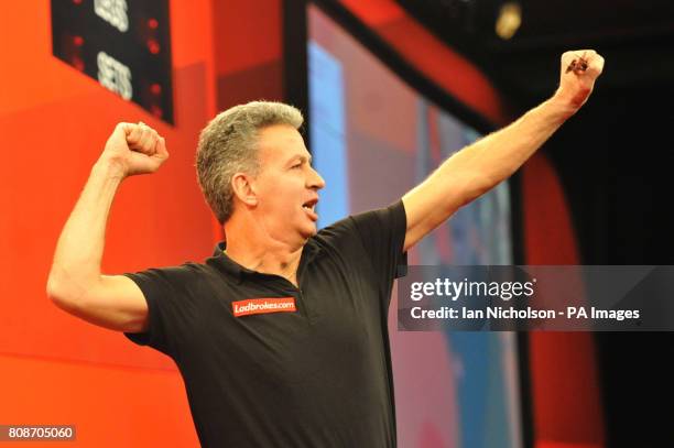 Magnus Caris celebrates in his First Round match with Dietmar Burger during the Ladbrokes.com World Darts Championship at Alexandra Palace, London.