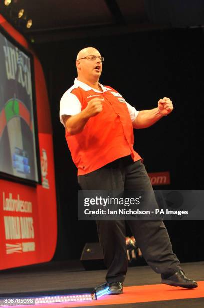Dietmar Burger celebrates in his First Round match with Magnus Caris during the Ladbrokes.com World Darts Championship at Alexandra Palace, London.