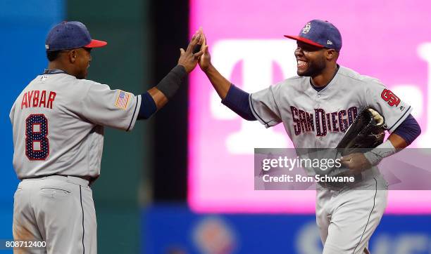 Erick Aybar of the San Diego Padres and Manuel Margot celebrate after defeating the Cleveland Indians 1-0 at Progressive Field on July 4, 2017 in...