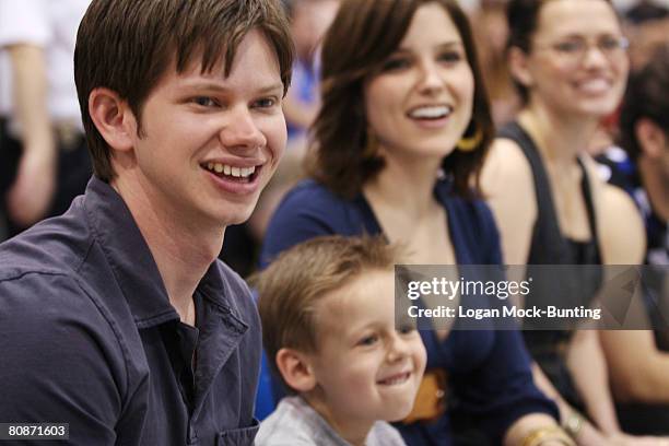 Actors, Lee Norris, Jackson Brundage and Sophia Bush watch the action during the 5th Annual James Lafferty/One Tree Hill Charity Basketball Game on...