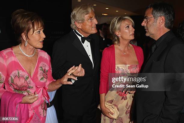 Katharina Baumann, her husband Manfred Baumann, Sabine Christiansen and her husband Norbert Medus attend the Innocence in Danger Art for Children...