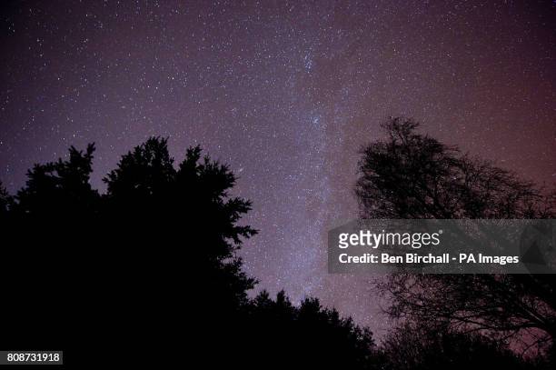 The light band of the Milky Way edge is seen in the centre of an image of the night sky over Exmoor National Park.