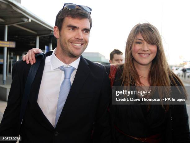 England cricketer James Anderson is greeted by his wife Daniella as he arrives at Manchester Airport, Manchester.