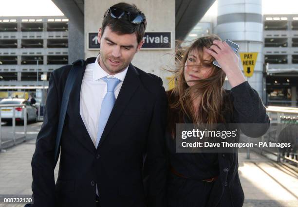 England cricketer James Anderson is greeted by his wife Daniella as he arrives at Manchester Airport, Manchester.