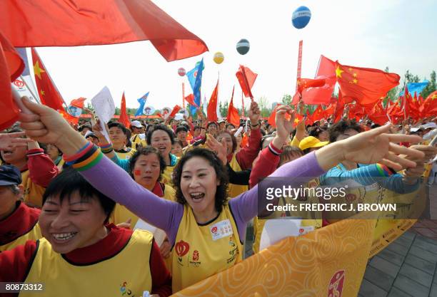 To go with OLY-2008-CHN-100DAYS by Charles Whelan Participants wave national flags at a fervent rally ahead of a walkathon on April 26, 2008 in...
