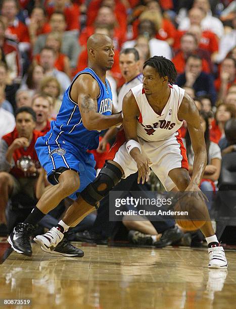 Chris Bosh of the Toronto Raptors tries to go around Keith Bogans of the Orlando Magic in Game Four of the Eastern Conference Quarterfinals at the...
