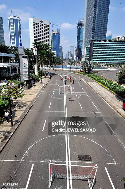 Youths take advantage of "Car Free Day" to play football on Jalan Thamrin in downtown Jakarta on April 27, 2008. Jakarta's Car Free Day, observed...