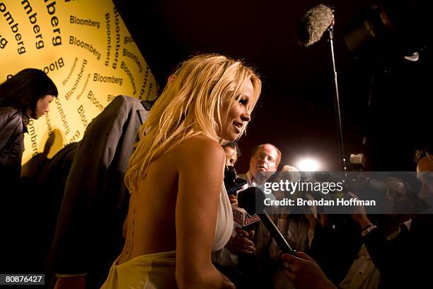 Actress Pamela Anderson speaks with the media at the Bloomberg afterparty following the White House Correspondents' Dinner April 26, 2008 in...