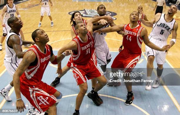 Tracy McGrady, Shane Battier and Chuck Hayes of the Houston Rockets battle for a rebound against the Utah Jazz in Game Four of the Western Conference...