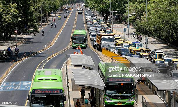 Buses ply on the road as commuters are stuck in a traffic jam at the Bus Rapid Transit corridor in New Delhi, on April 27, 2008. India's capital has...