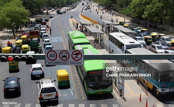 Buses and other vehicles wait at a redlight at the Bus Rapid Transit corridor in New Delhi, on April 27, 2008. India's capital has put the brakes on...