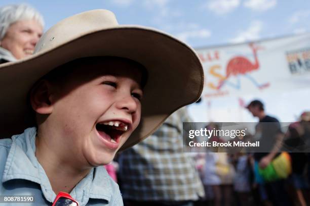 Year-old Jackson Nott from Brisbane reacts as contestants compete in the Bashville Drags Fashion Show, a fund raising event for the Royal Flying...