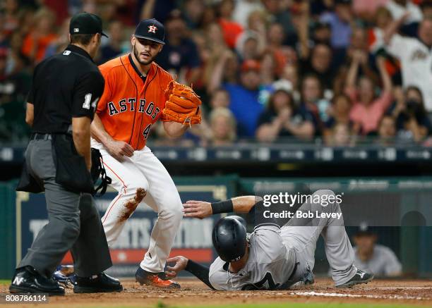 Austin Romine of the New York Yankees is tagged out by Lance McCullers Jr. #43 of the Houston Astros as he attempts to score at Minute Maid Park on...