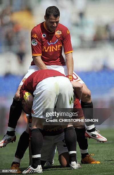 Roma's Simone Perotta jumps over Brazilian Amantino Mancini who jubilates as he scores the third goal during AS Roma vs Torino Italian Serie A...