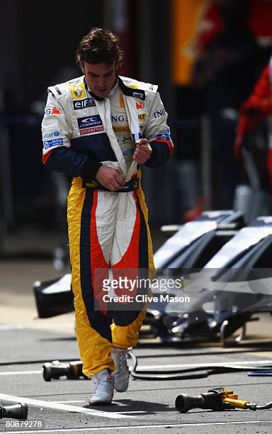 Fernando Alonso of Spain and Renault walks down the pitlane after retiring from the Spanish Formula One Grand Prix at the Circuit de Catalunya on...