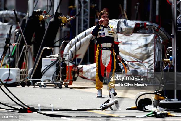 Fernando Alonso of Spain and Renault walks down the pitlane after retiring from the Spanish Formula One Grand Prix at the Circuit de Catalunya on...