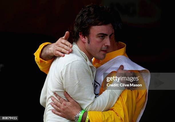 Fernando Alonso of Spain and Renault walks down the pitlane after retiring from the Spanish Formula One Grand Prix at the Circuit de Catalunya on...