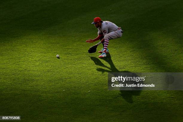 Center fielder Billy Hamilton of the Cincinnati Reds fields a single off the bat of Charlie Blackmon of the Colorado Rockies during the fifth inning...
