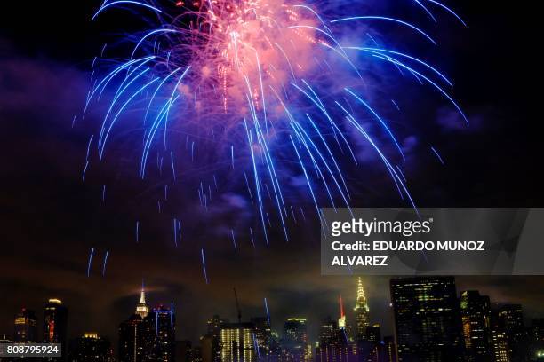 The Empire state Building and the Christal Building are seen during the Macy's 4th of July fireworks show from Queens, New York on July 4, 2017.