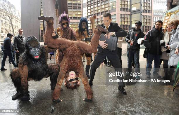 The cast of Cirque du Soleil's new show, Totem, recreate Darwin's iconic evolution of man scene to shoppers and office workers at London's Liverpool...