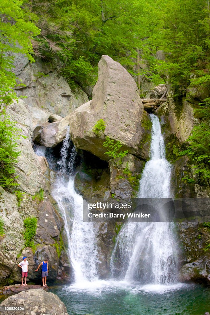 Men climbing near waterfall, Massachusetts