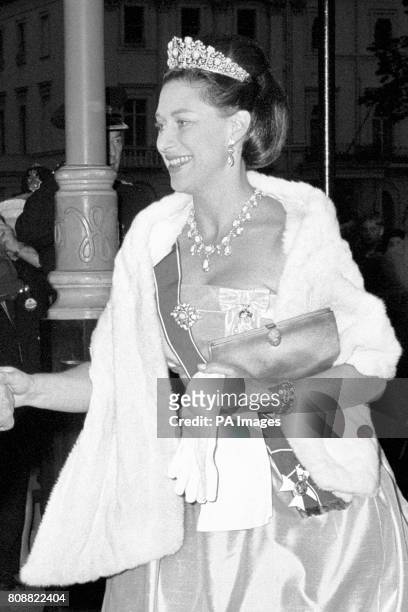 Princess Margaret arrives at The Embassy in Belgrave Square, London, to attend the dinner given by Austria's President Franz Jonas. Her dress is...