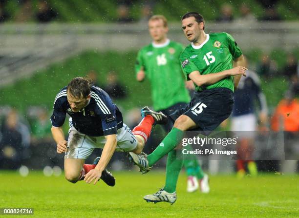 Northern Ireland's David Healy sythes down Scotland's Christophe Berra during the Carling Nations Cup match at the Aviva Stadium, Dublin, Ireland.